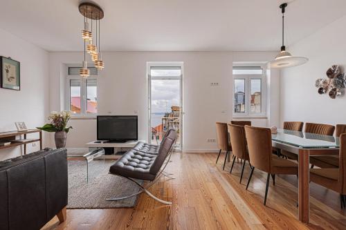 a living room with a table and a dining room at Cortes Apartment in Lisbon Historic Neighborhood in Lisbon