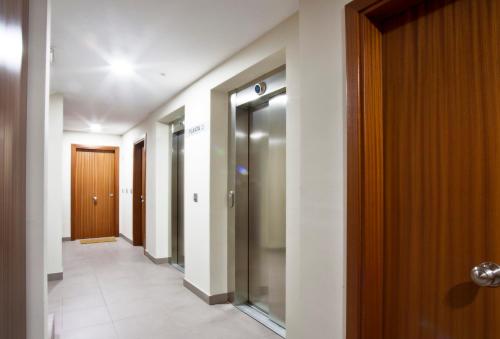 a corridor of a building with doors and a walkway at Andorra4days Soldeu - El Tarter in Soldeu