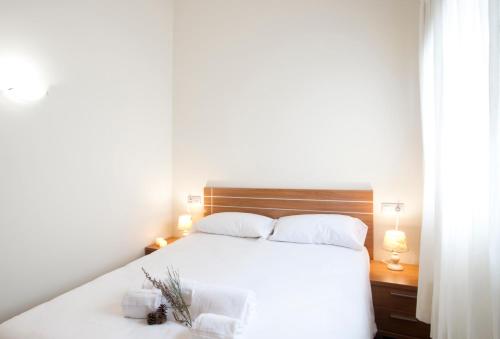 a bedroom with a white bed with two pillows at Andorra4days Soldeu - El Tarter in Soldeu