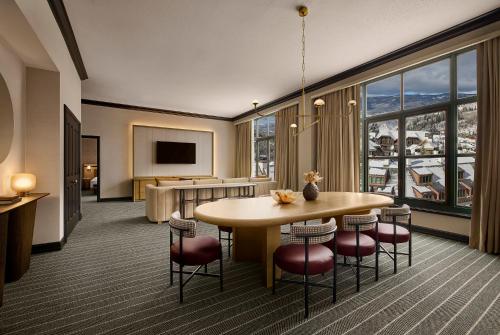 a hotel room with a table and chairs and a large window at Park Hyatt Beaver Creek Resort and Spa, Vail Valley in Beaver Creek