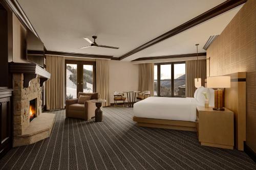 a hotel room with a bed and a fireplace at Park Hyatt Beaver Creek Resort and Spa, Vail Valley in Beaver Creek