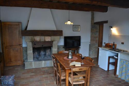a living room with a table and a fireplace at Agriturismo Nestore in Nestore