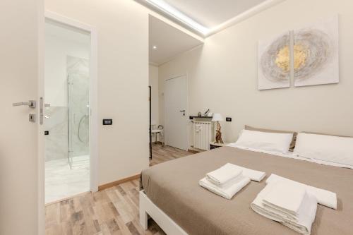 a white bedroom with a bed and a shower at Le Colonne Di San Luca Affittacamere in Genoa