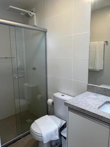 a bathroom with a toilet and a glass shower at Amerigo Exclusive in Morro de São Paulo