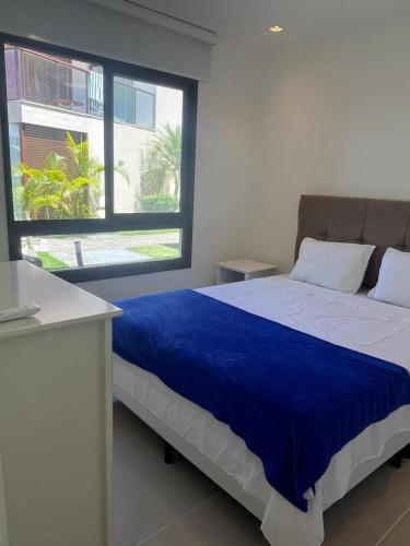 a bedroom with a large bed with a blue blanket at Amerigo Exclusive in Morro de São Paulo