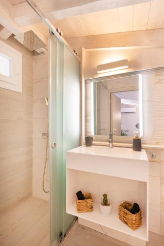 a bathroom with a sink and a mirror at Pythagoreio Blue Street Upper Floor Apartment in Pythagoreio