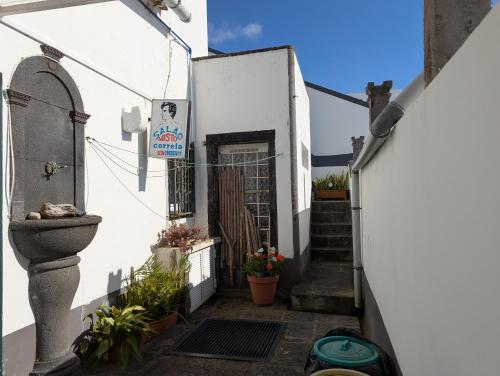 a stairway leading to a white building with a door at quarto duplo downtown in Ponta Delgada