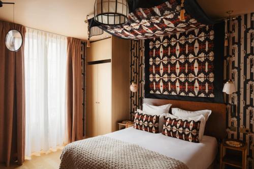 a bedroom with a bed and a large window at La Bohème Montmartre - Studios & Apartments de luxe au Sacré Coeur in Paris