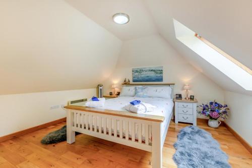 a bedroom with a white bed in a attic at 1 Bed in Piltdown oc-t36330 in Fletching