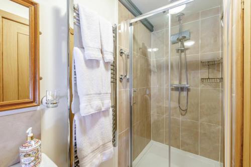 a bathroom with a shower with a glass door at 1 Bed in Piltdown oc-t36330 in Fletching