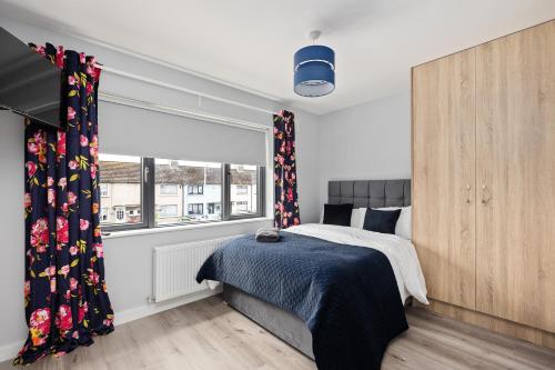 a bedroom with a bed and a window at North Dublin Premier Oasis in Dublin