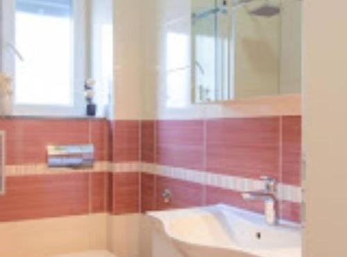a bathroom with a sink and a mirror at Apartment Didi in Trogir