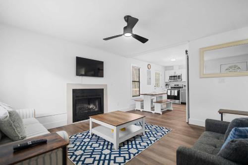 a living room with a couch and a fireplace at 8 Minutes to UNC - Outdoor Deck - Washer and Dryer in Chapel Hill
