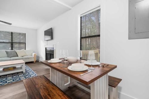 a living room with a table and a couch at 8 Minutes to UNC - Outdoor Deck - Washer and Dryer in Chapel Hill