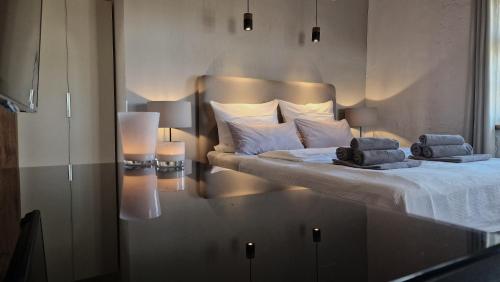 a bedroom with a large bed with two pillows on it at Die Mühle Appartements in Samtens