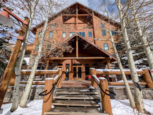 a home with a wooden stairway leading to the front door at Arapahoe Lodge 8105 by SummitCove Lodging in Keystone