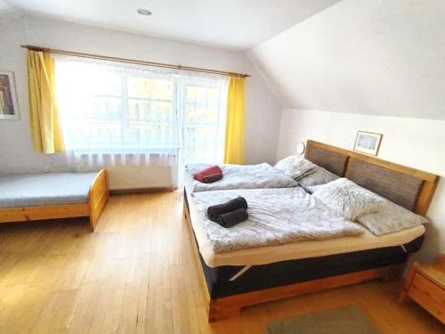 a bedroom with a bed and a window at Penzion Andy in Děčín