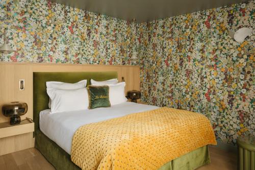 a bedroom with a bed with floral wallpaper at La Bohème Montmartre - Studios & Apartments de luxe au Sacré Coeur in Paris