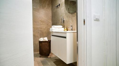 a bathroom with a white sink and a mirror at La Casa del Faro in Taranto