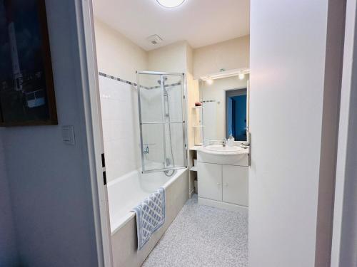 a bathroom with a shower tub and a sink at Cottage en baie in Cayeux-sur-Mer