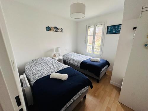 a bedroom with two beds and a window at Cottage en baie in Cayeux-sur-Mer