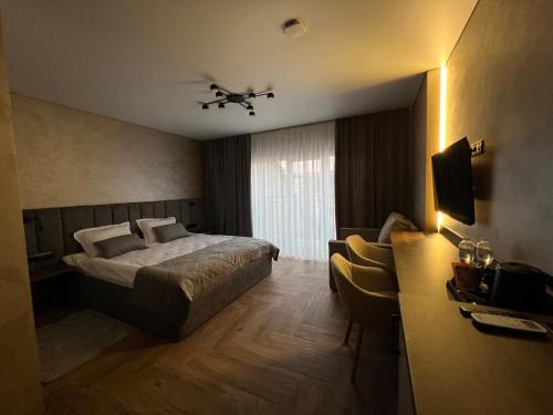 a hotel room with a bed and a window at Amaro Hotel Uman in Uman