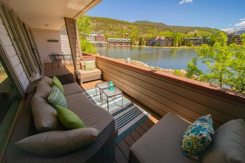 a balcony with couches and a view of a lake at Argentine 1511 by SummitCove Lodging in Colorado in Keystone