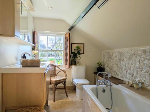a bathroom with a tub and a sink and a toilet at Blackbird Cottage near Appledore in Bideford