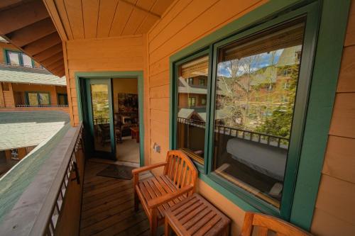 a porch with a bench and a window on a house at Arapahoe Lodge 8116 by SummitCove Lodging in Keystone