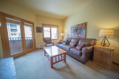 a living room with a couch and a coffee table at Arapahoe Lodge 8116 by SummitCove Lodging in Keystone