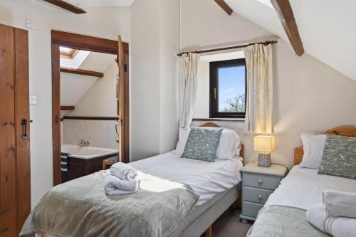 two beds in a small room with a sink at 4 Bed in Newport oc-88913 in Porchfield