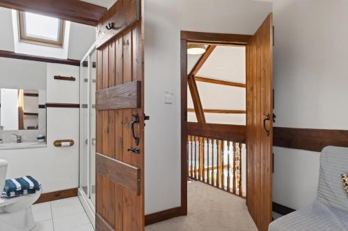 a bathroom with a wooden door and a sink at 4 Bed in Newport oc-88913 in Porchfield