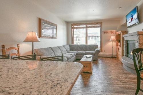a living room with a couch and a fireplace at Black Bear 8052 by SummitCove Lodging in Keystone