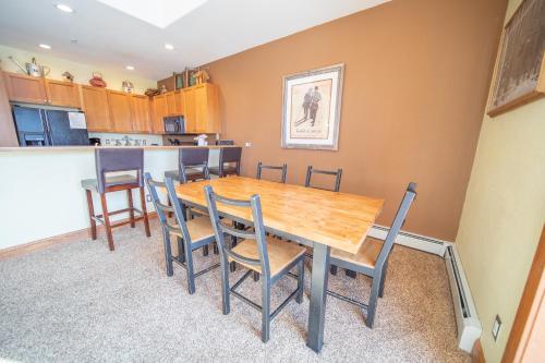 a dining room with a wooden table and chairs at Antlers Gulch 303 by SummitCove Lodging in Colorado in Keystone