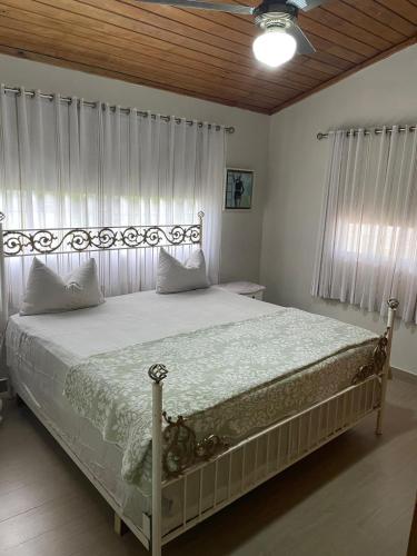 a bedroom with a large bed with white sheets at Tropical Landhouse in Sánchez
