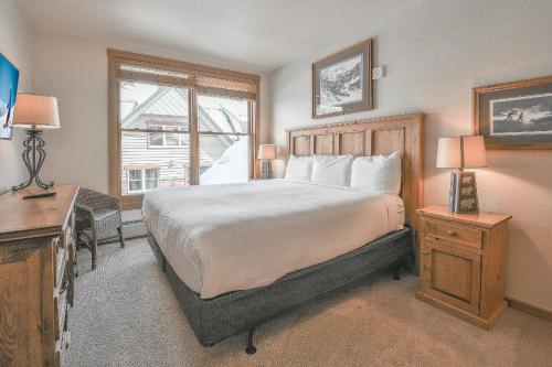 a bedroom with a bed and a desk and a window at Black Bear 8052 by SummitCove Lodging in Keystone