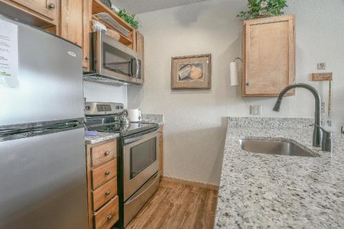 a kitchen with a stainless steel refrigerator and a sink at Black Bear 8052 by SummitCove Lodging in Keystone