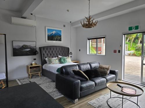 a living room with a couch and a bed at City Living in New Plymouth