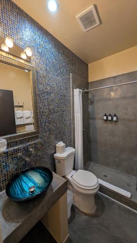 a bathroom with a sink and a toilet and a shower at The Crescent Hotel Beverly Hills in Los Angeles