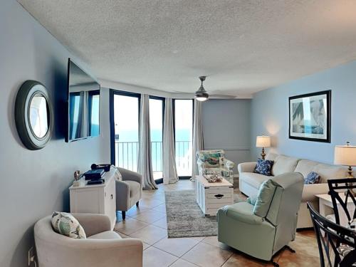a living room with a couch and chairs at Phoenix III #3146 in Orange Beach