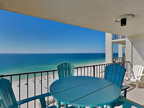 a table and chairs on a balcony with the beach at Phoenix III #3146 in Orange Beach