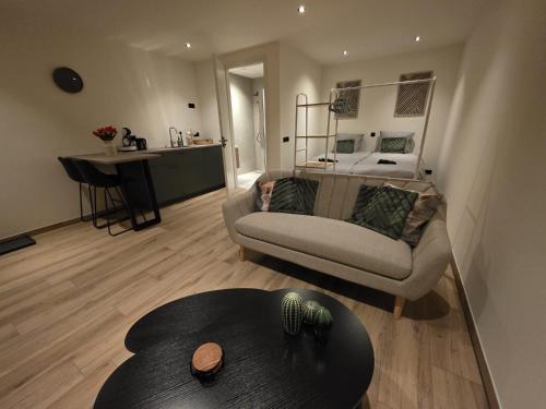 a living room with a couch and a table at Alpa Farm Rouveen in Rouveen