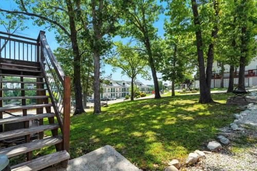 a staircase in a park with trees and a building at King Resort in Branson