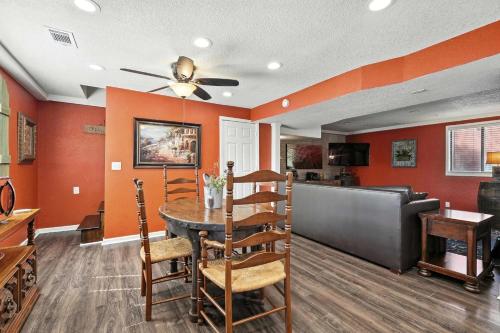 a dining room with orange walls and a table and chairs at King Resort in Branson