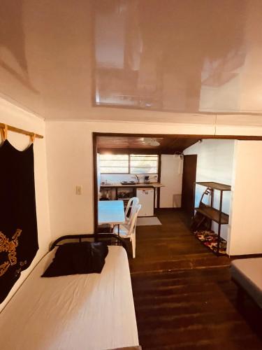a room with a bed and a table in a trailer at Noni garden apartment in Tamarindo
