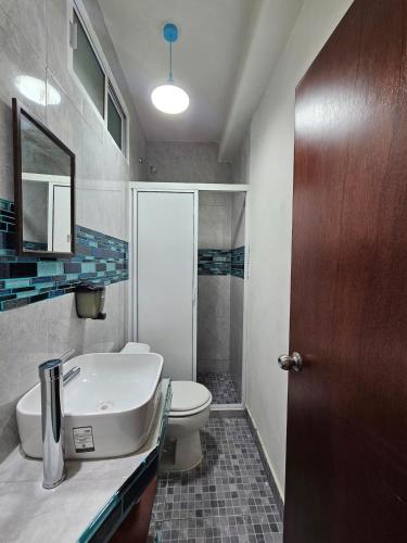 a bathroom with a sink and a toilet at Alojamiento Turquesa in Barrio Nuevo