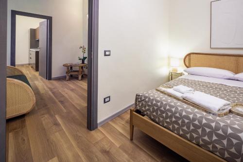a bedroom with a bed and a mirror at Small Luxury In Centro Storico in Parma