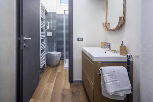 a bathroom with a sink and a mirror at Small Luxury In Centro Storico in Parma