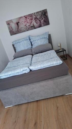 a bed with pillows on it in a bedroom at Gutliegende Wohnung in Maybach
