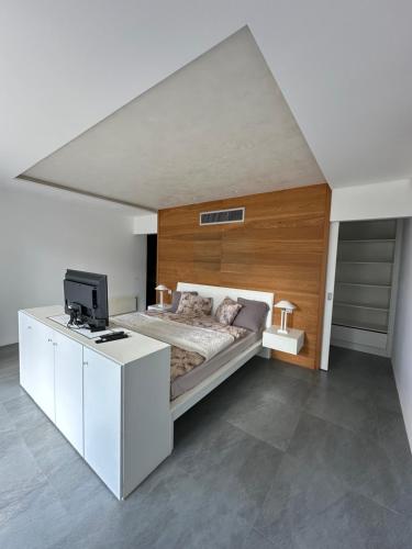 a bedroom with a bed and a desk with a tv at Villa Nika in Bečići